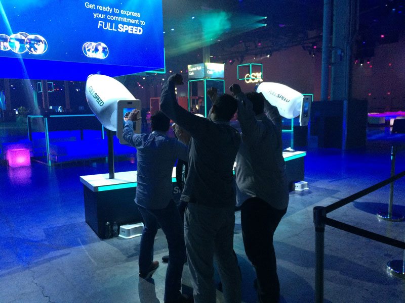 Attendees cheering with fists raised after using the Full Speed Machine cannons