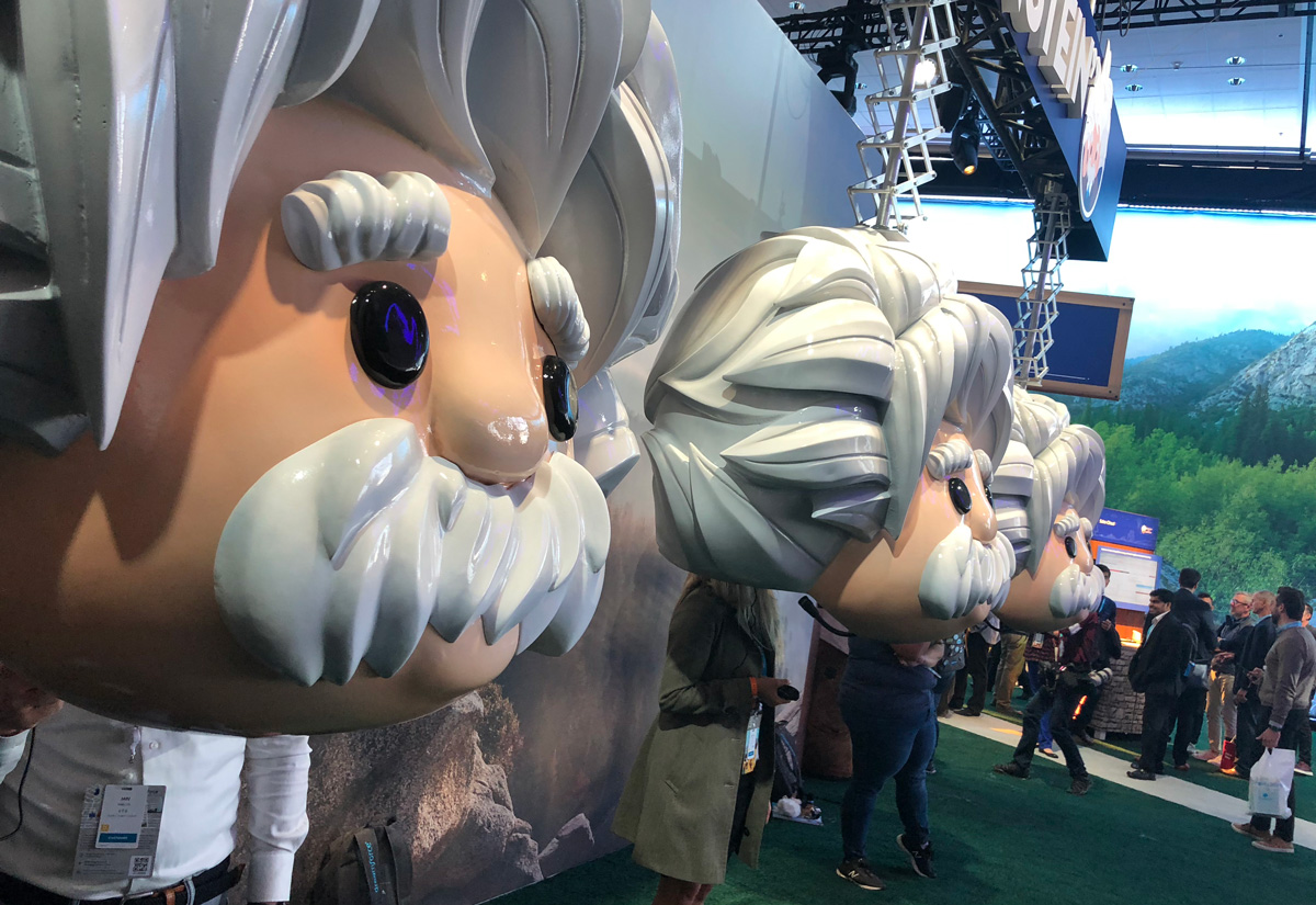 Life-size Einstein bobbleheads with screens built into their chests, lined up at the Hey Einstein activation