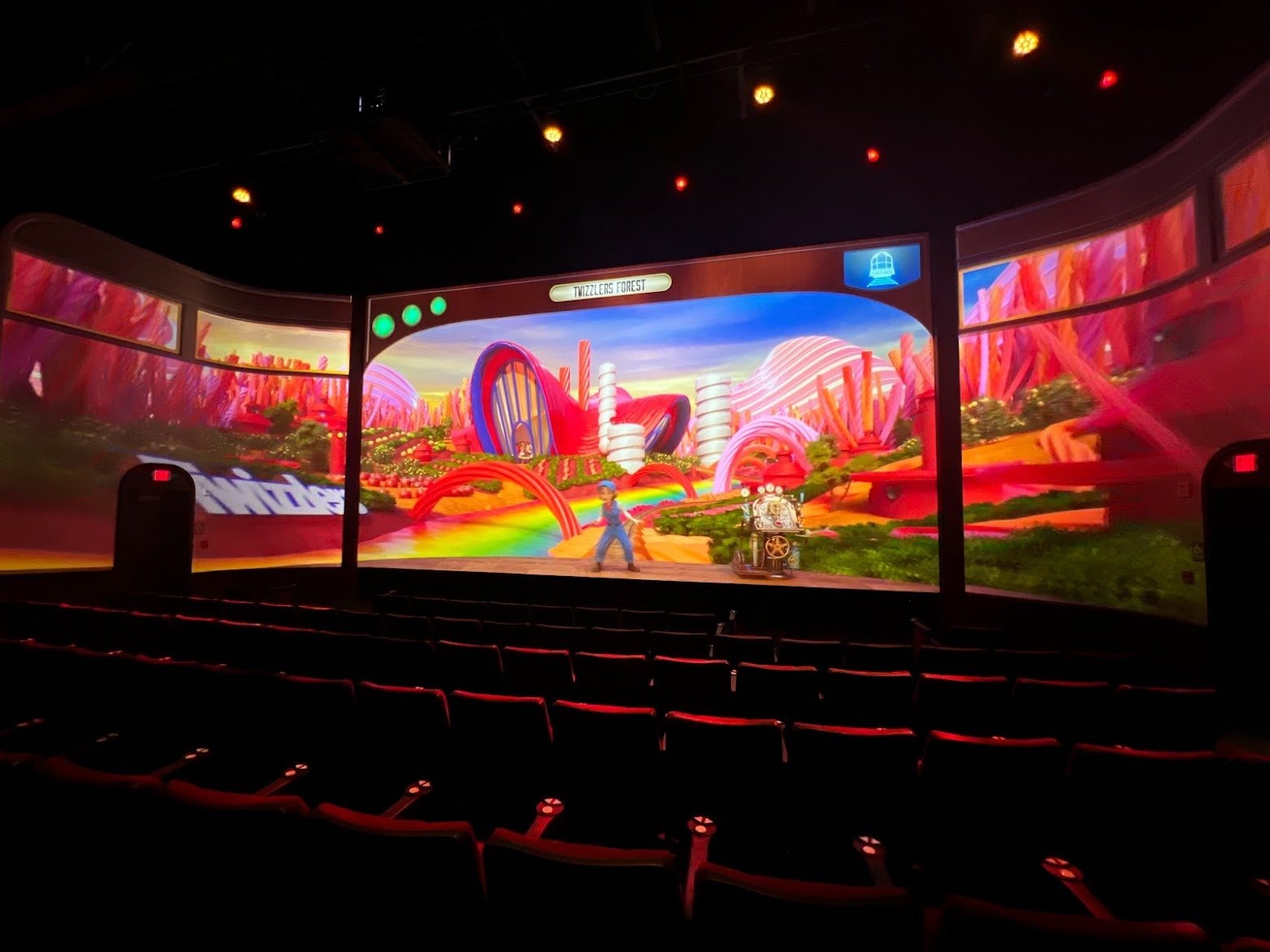 Twizzlers Forest sequence on the theater screen, host character on stage