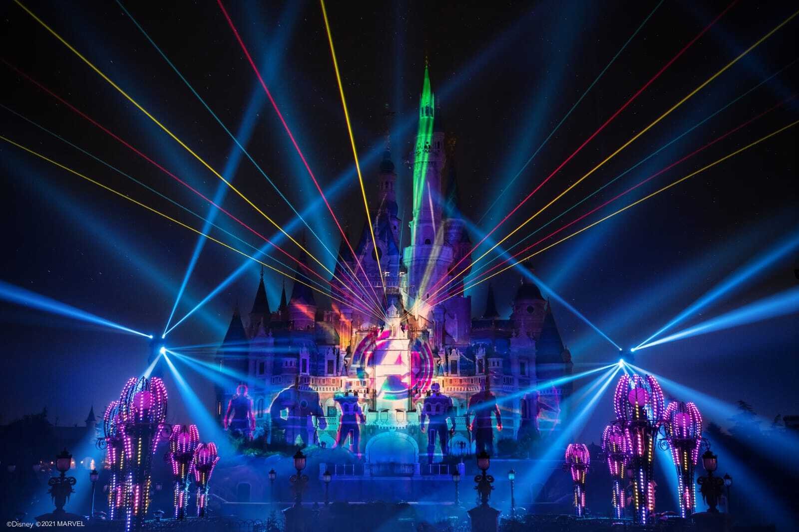 Rainbow laser beams and projected Marvel imagery on the castle
