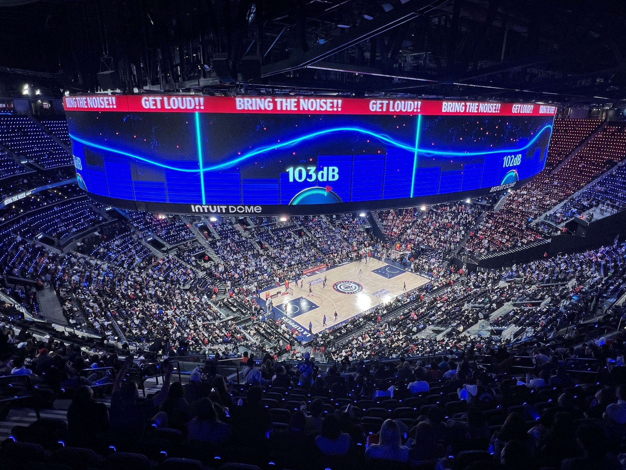 Wide shot of the arena bowl and Halo screen during a game