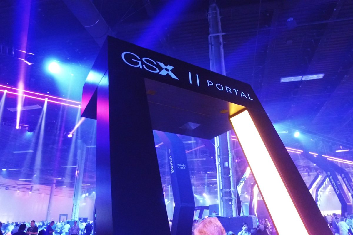 Wide shot of attendees gathered at the GSX Portal arch entrance