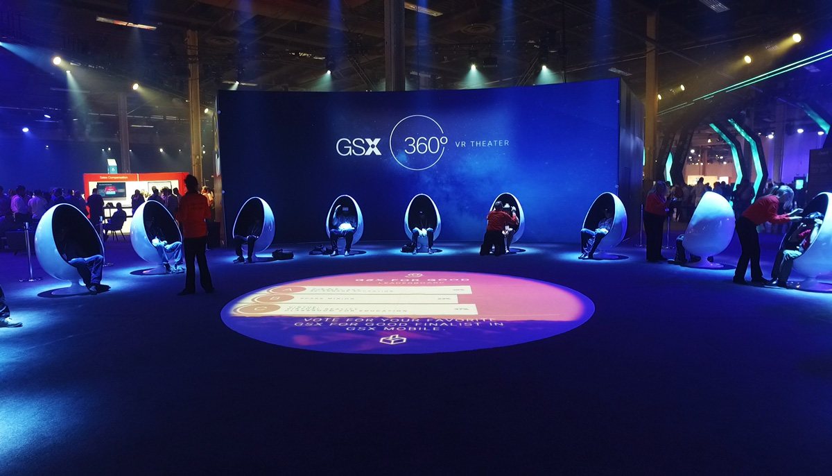 Wide shot of the GSX360 VR Theater with a floor projection inviting attendees to vote