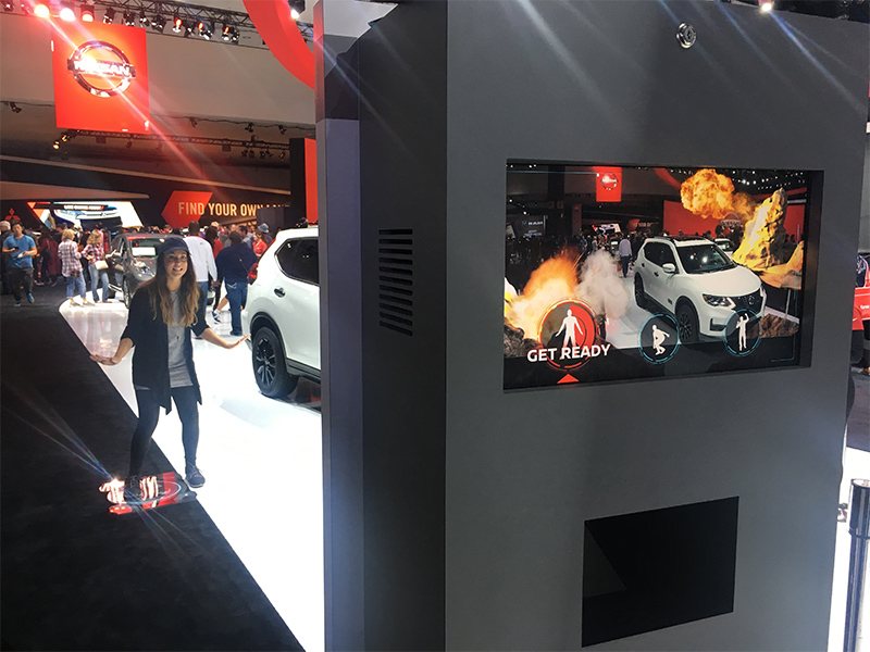 Guest standing on the floor marker as the kiosk screen displays Get Ready